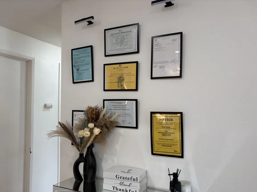 The home's Adult Family Home License, business license and required notices framed on the wall