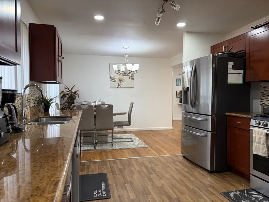 The kitchen with granite counters, looking through to the dining table